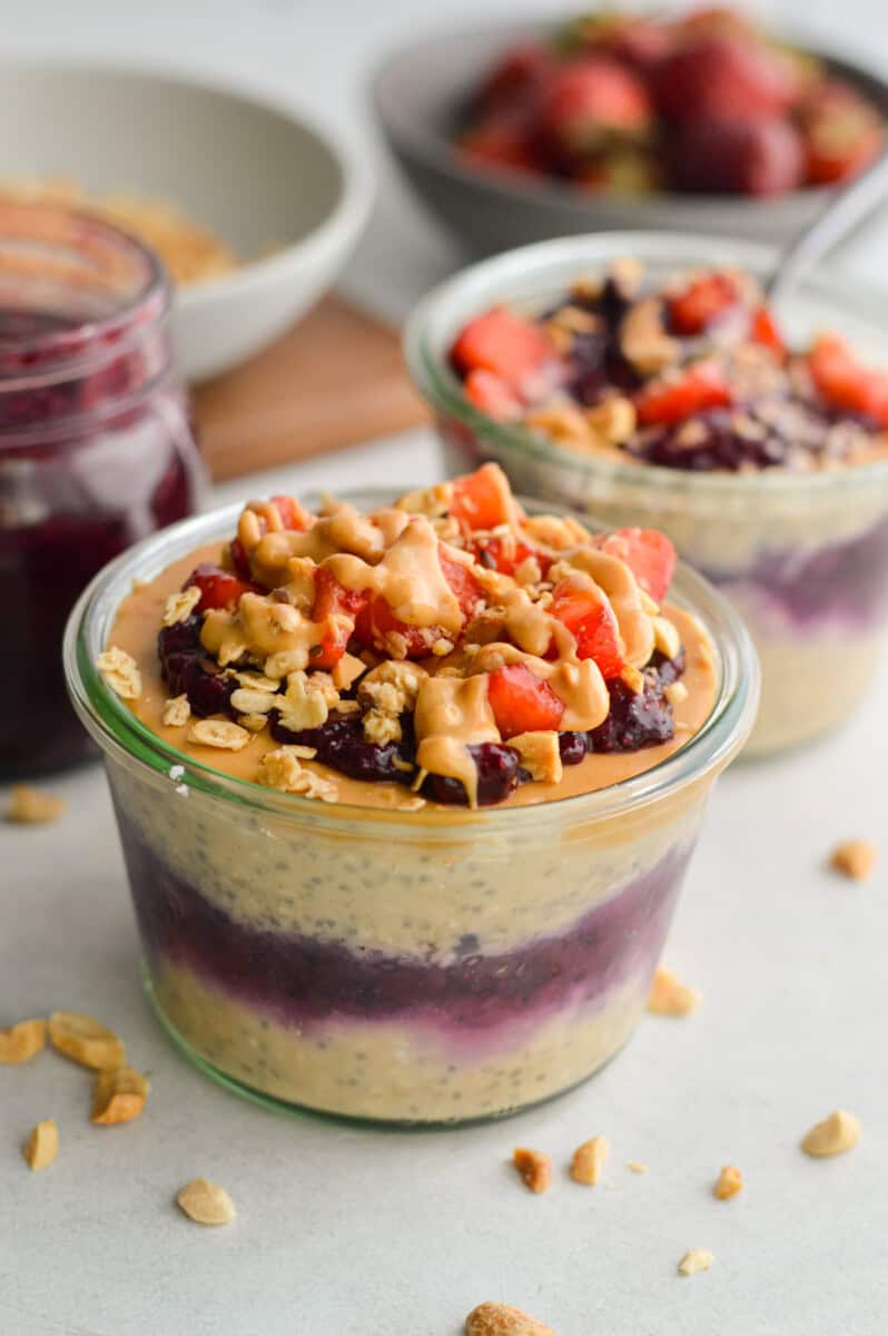 Jar of pb and j overnight oats topped with berries.