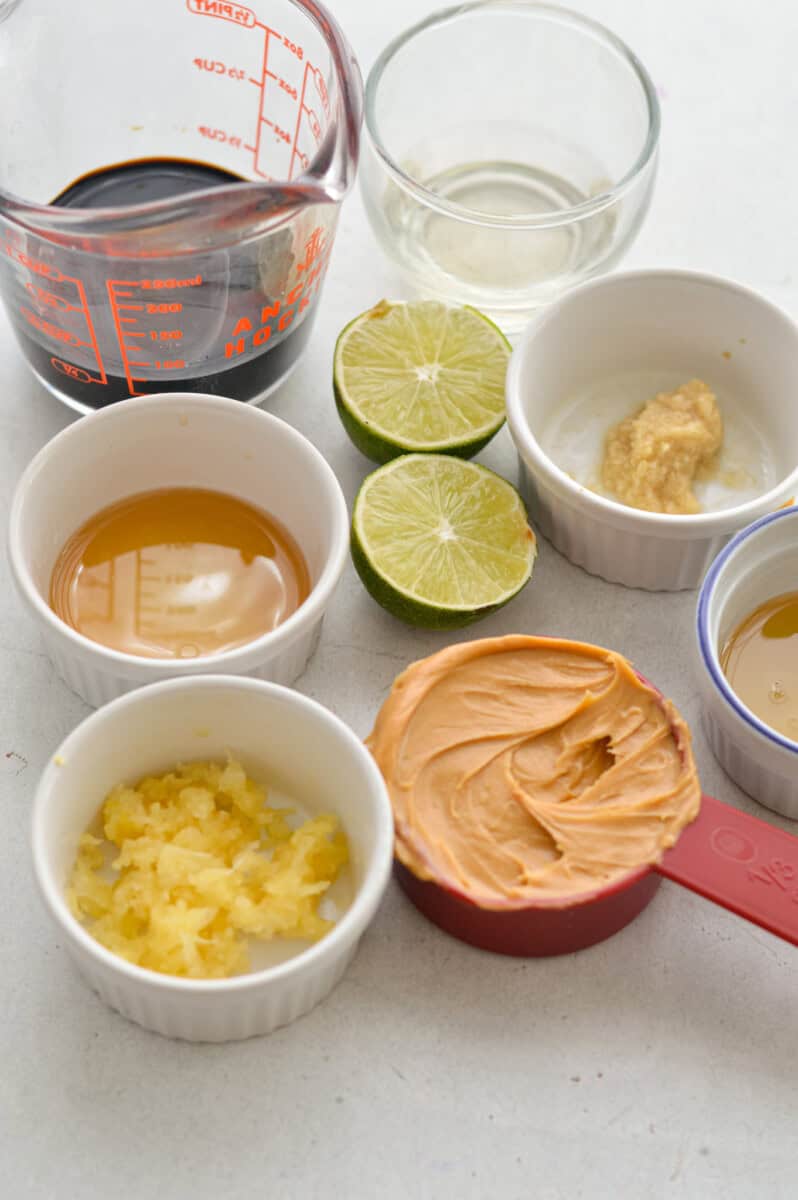 Ingredients including peanut butter, soy sauce, garlic, ginger, sesame oil, honey, sriracha and lime juice,