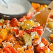 Close up of scoopng perfect roasted veggies and bowl of honey mustard sauce.
