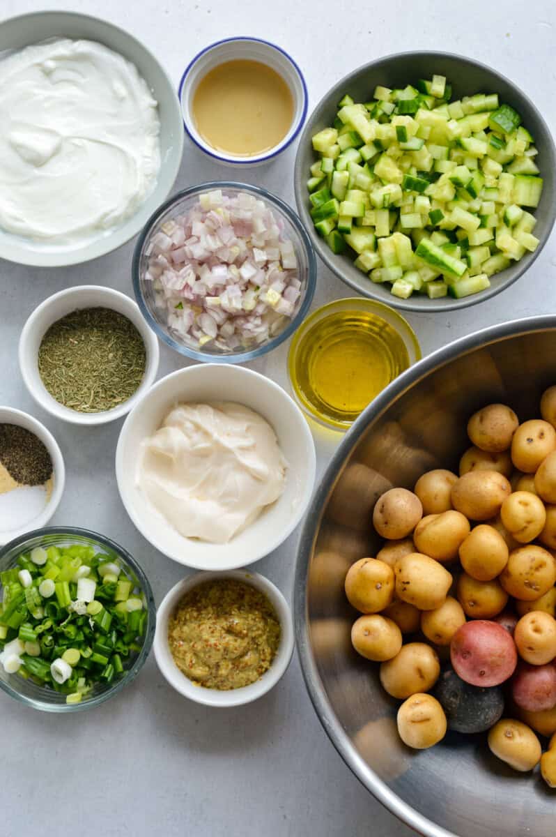 Ingredients including potato, mayo, greek yogurt, celery, spices, olive oil, red onion, green onion.