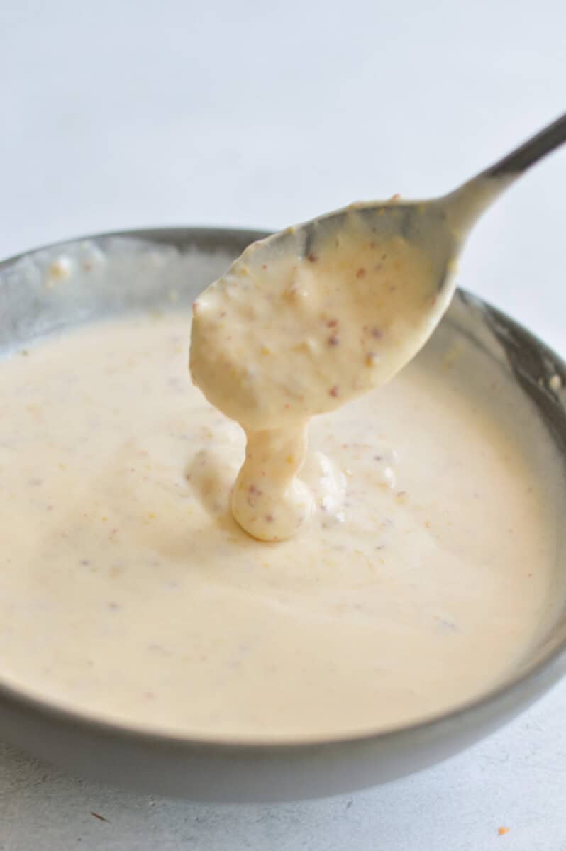 Mixing together a honey mustard sauce for roasted vegetables.