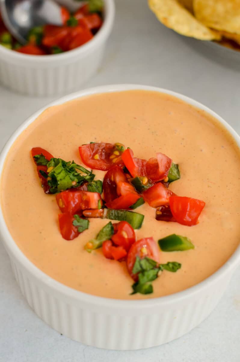 Topping cottage cheese queso with pico de gallo.