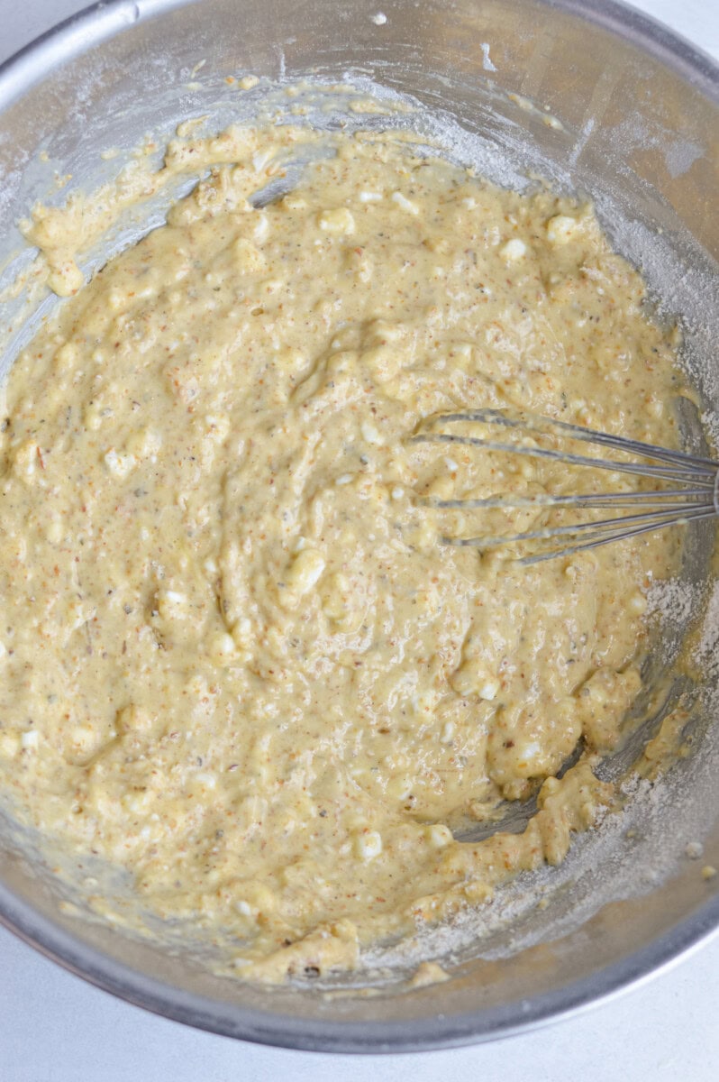 Mixing together wet and dry ingredients.