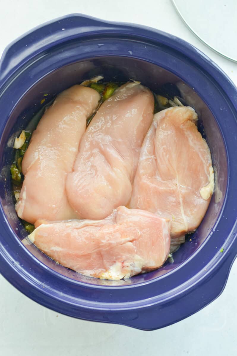 Layering chicken breasts in crockpot.