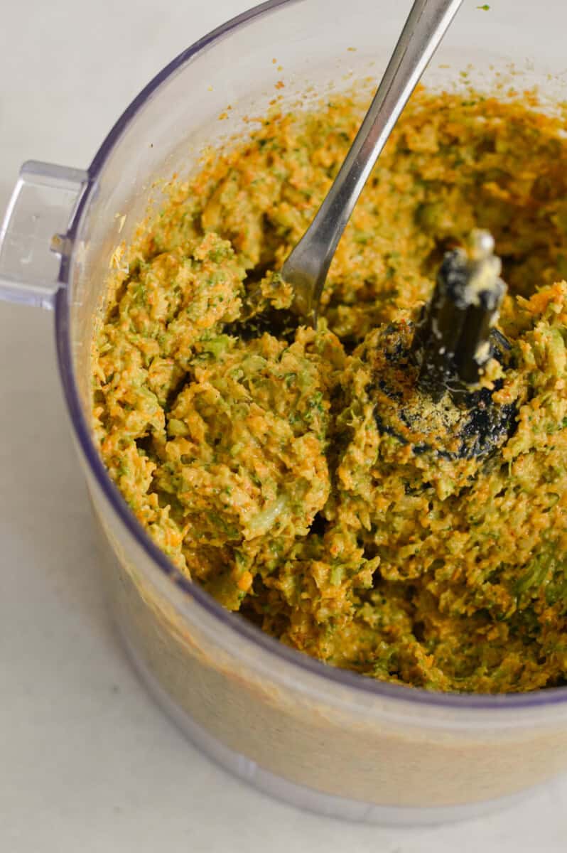 Blending broccoli bite mixture in a food processor.
