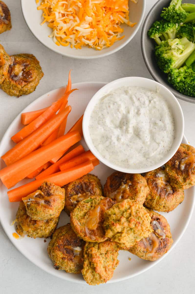 Snack plate with broccoli bites, dip and carrot sticks.