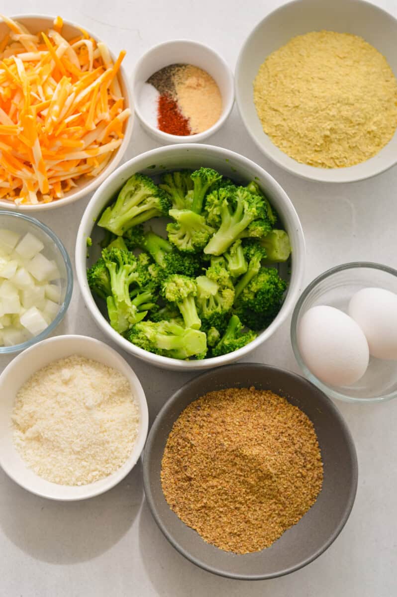 Ingredients including broccoli, eggs, parmesan, cheddar cheese, spices and flaxseed.