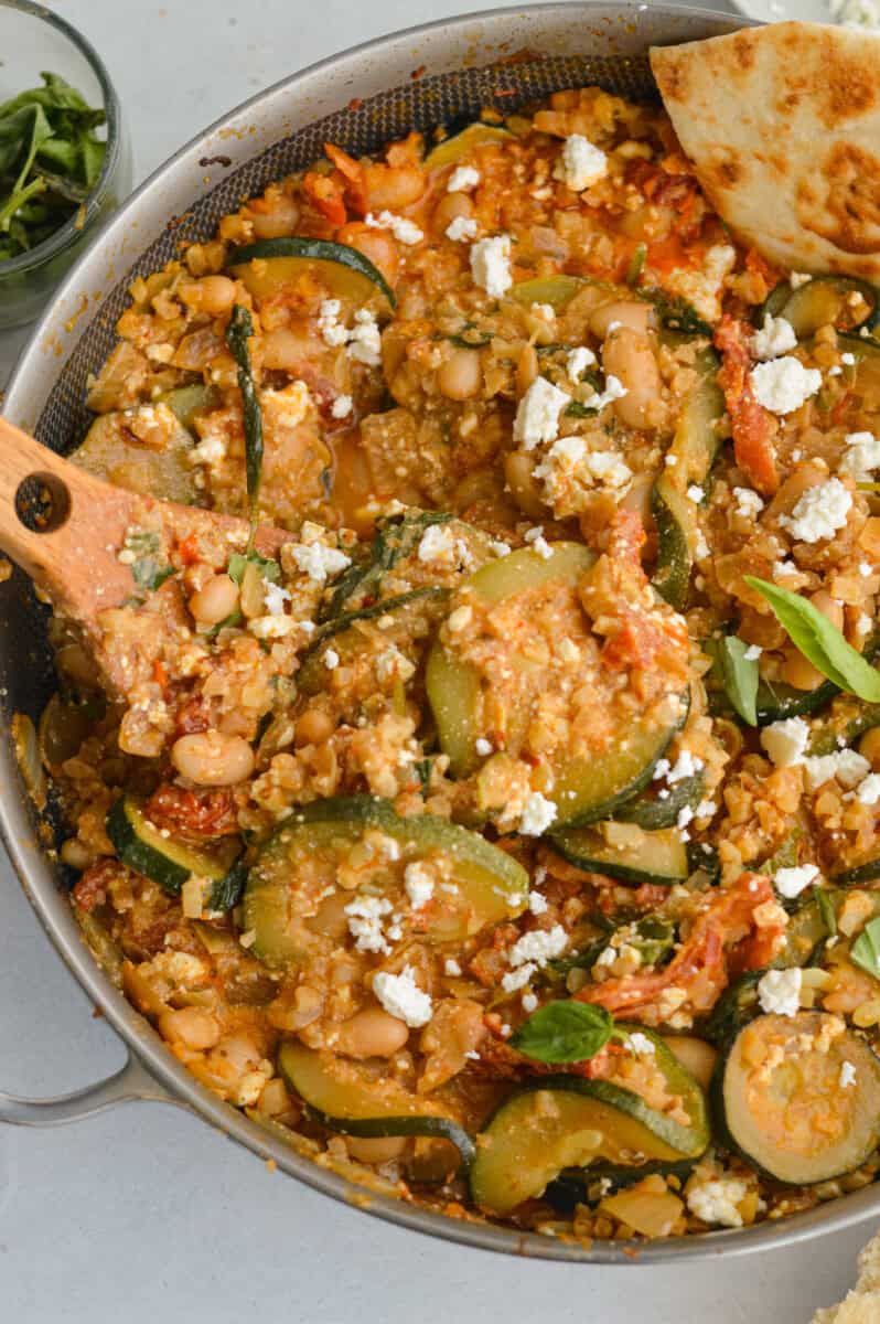Birds eye of cheesy white bean tomato bake with feta on top.
