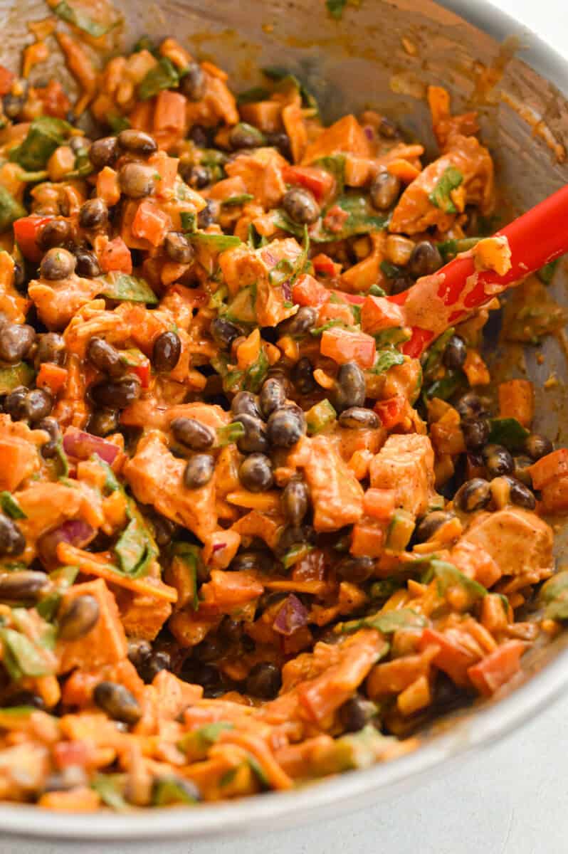 Mixing together BBQ chicken and black bean filling.