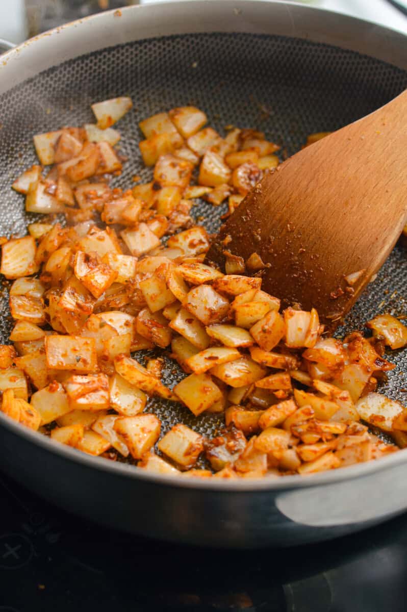 Cooking onions and garlic with spices.