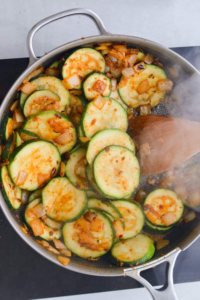 Cooking zucchini in a pan.