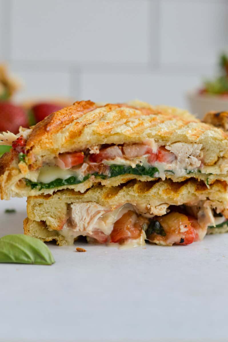 Balsamic strawberry and chicken sandwich cut in half.
