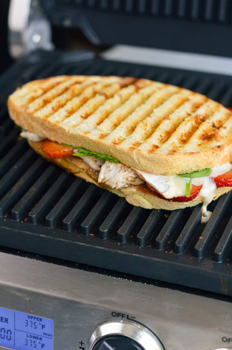 Grilling strawberry sandwich in a panini press.