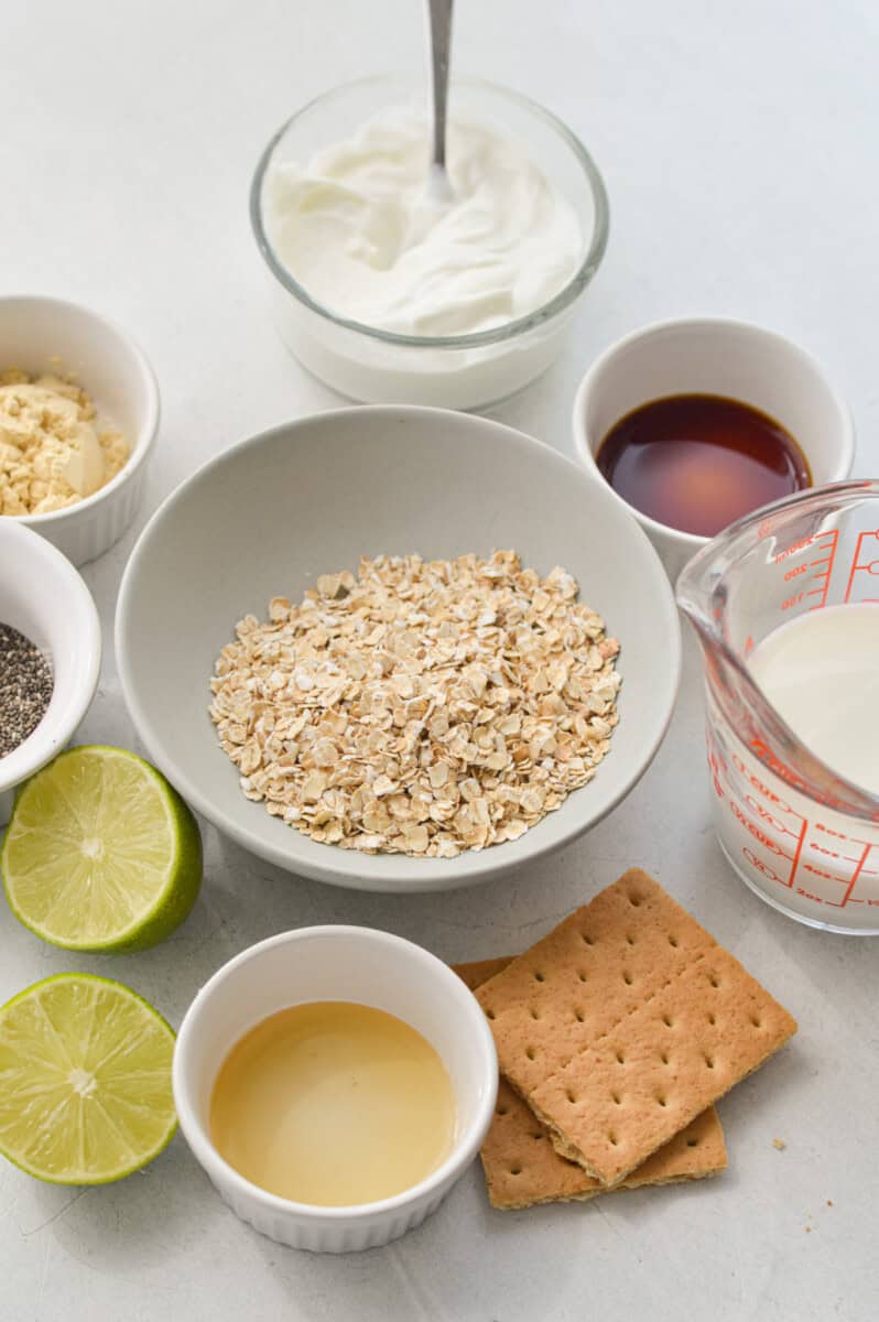 Ingredients including oats, graham crumbs, greek yogurt, key lime, milk, vanilla, honey, protein powder.