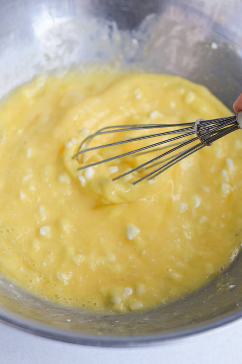 Whisking together eggs and cottage cheese.