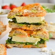 Two halves of a bagel breakfast sandwich stacked.