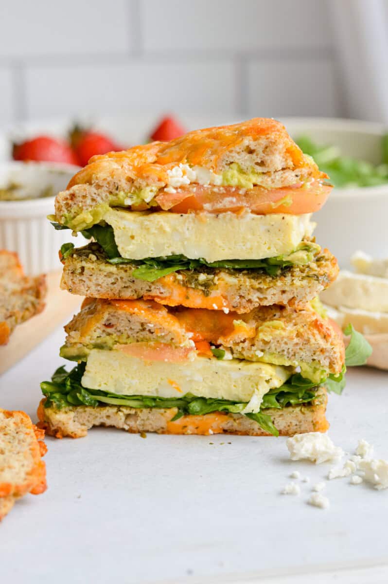 Two halves of a bagel breakfast sandwich stacked.