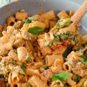 Pan of pasta with sausage and broccoli.