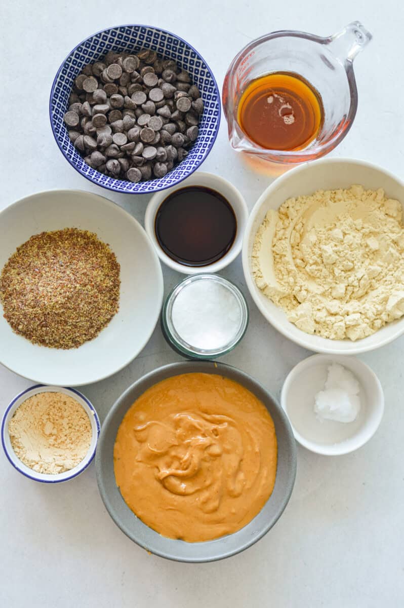 Ingredients including peanut butter, protein powder, flaxseed, chocolate maple syrup, and vanilla.