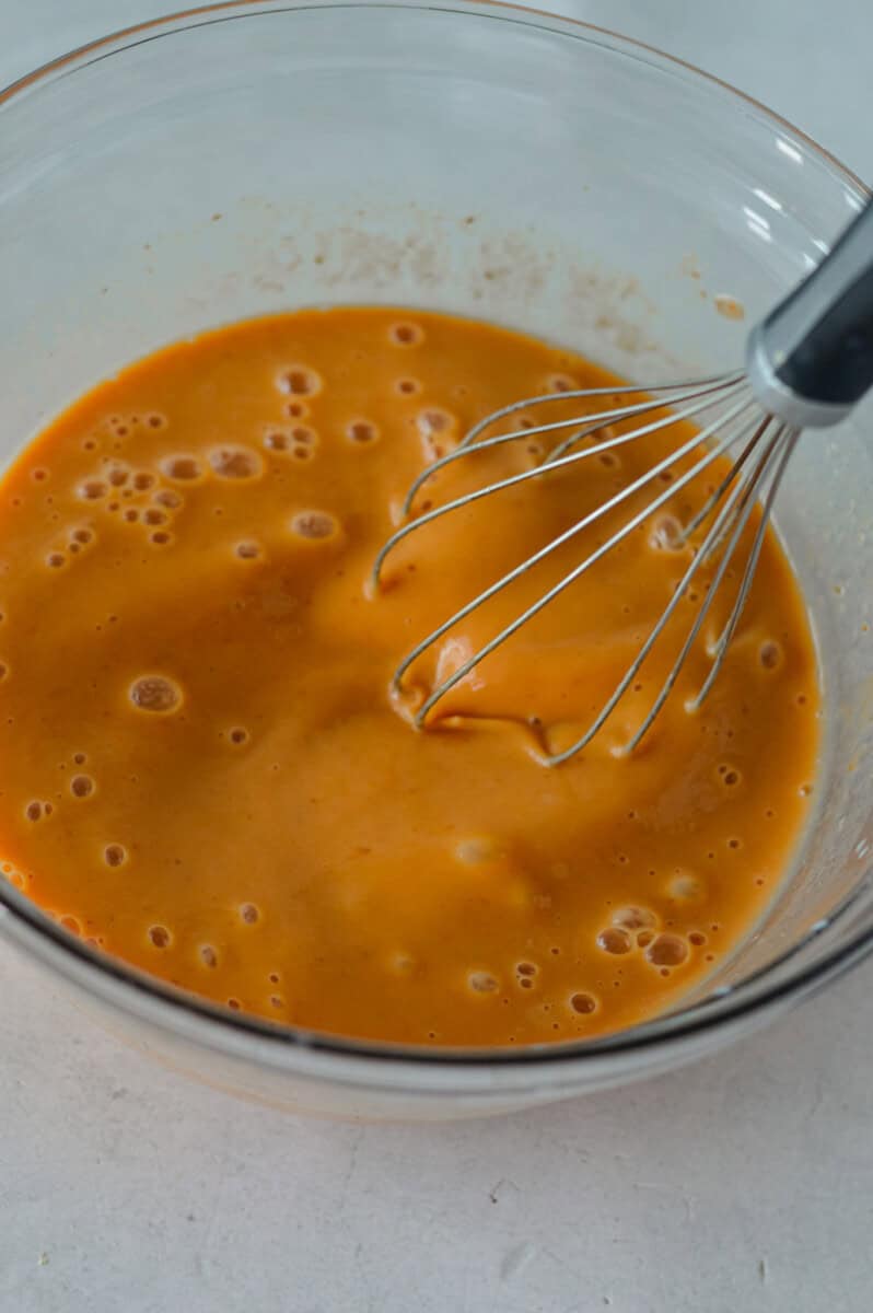 In a large bowl, whisk together egg, maple syrup, pumpkin puree and milk.
