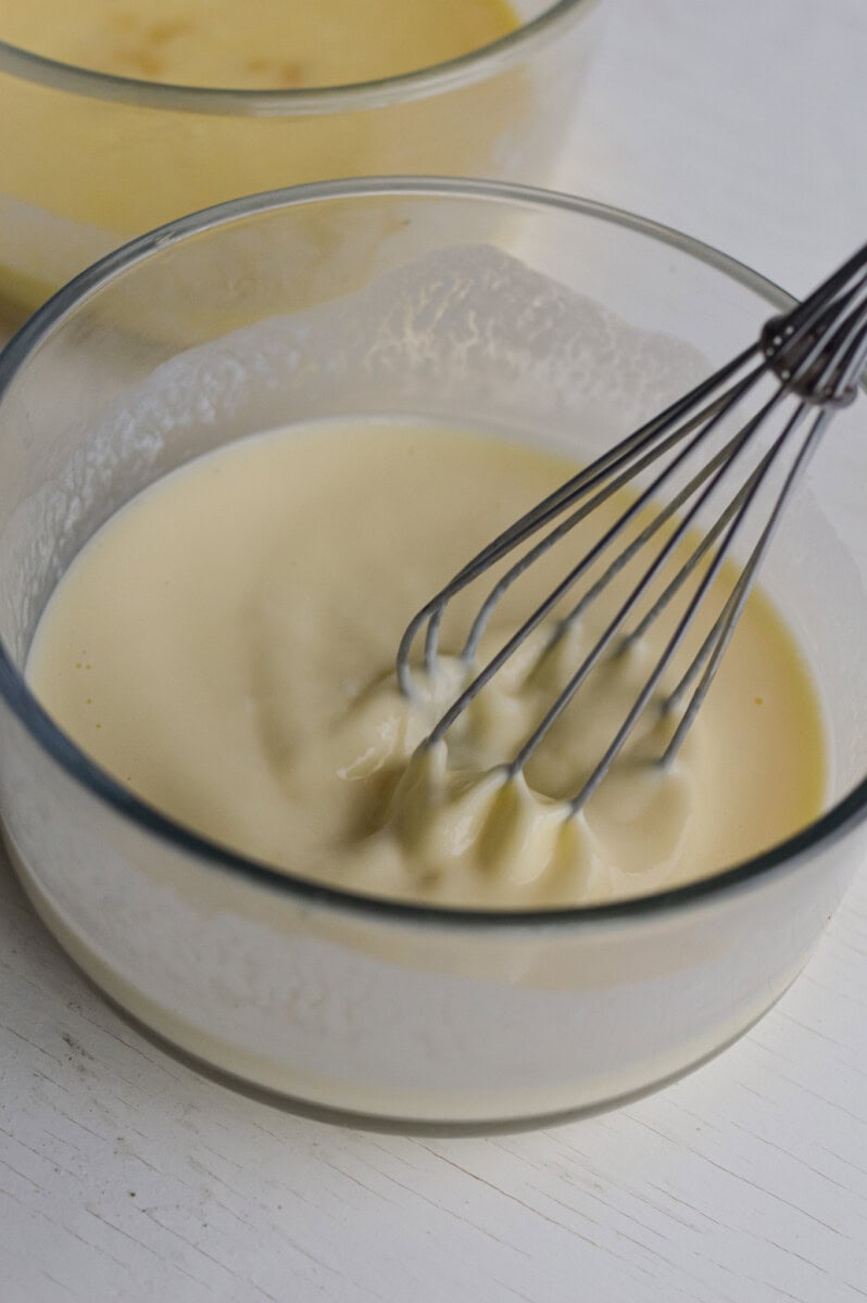 Whisking together wet ingredients in a bowl.