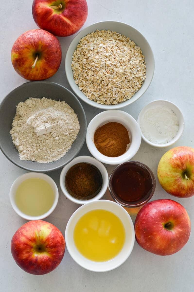 Ingredients including apples, oats, oat flour, lemon, butter, maple syrup, cinnamon, vanilla and cornstarch.