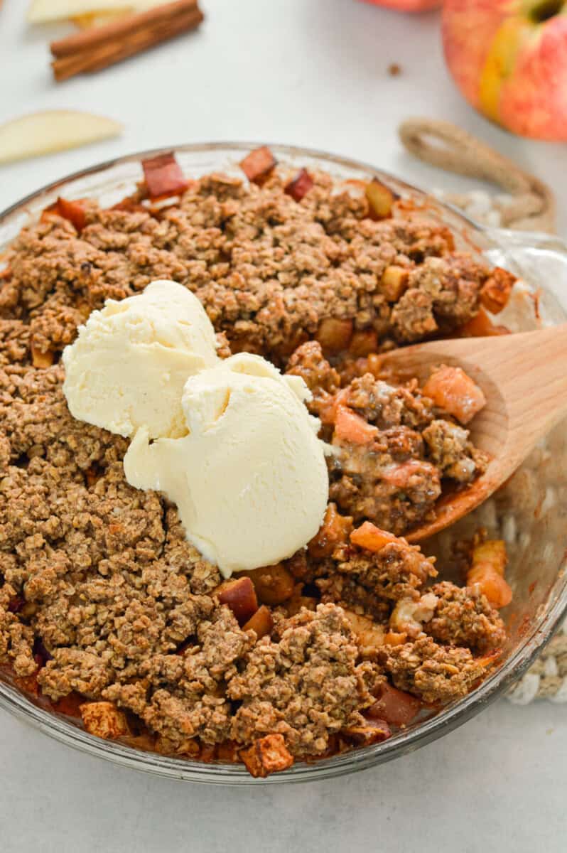 Birds eye of healthy apple crumble with ice cream.