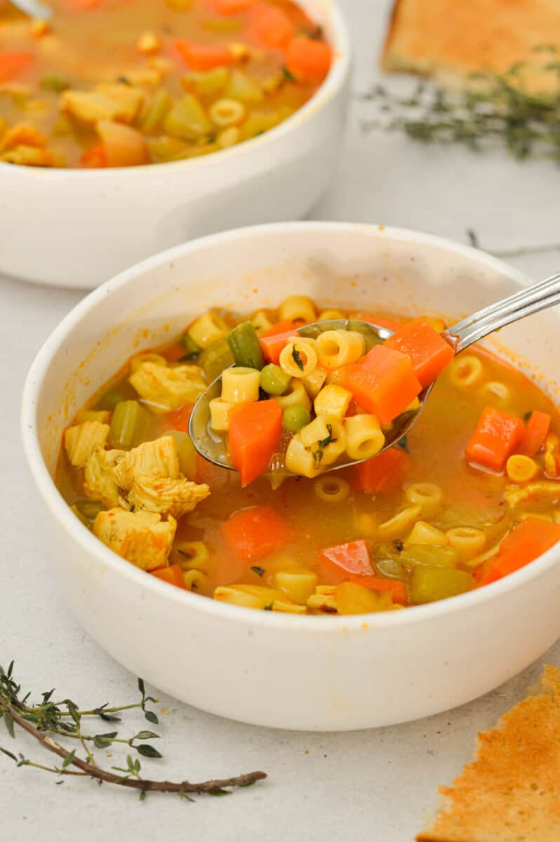 A bowl of chicken and vegetable soup.
