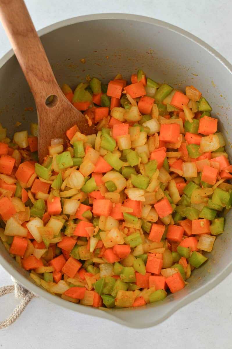 Cooking mirepoix in a pot.