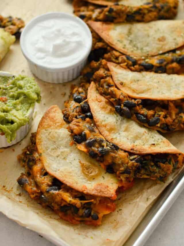 Tray of crispy chicken baked tacos served with greek yogurt and guac.