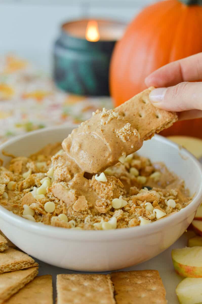 Dipping a graham cracker in pumpkin pie cream cheese dip.