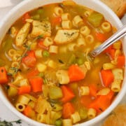 Birds eye of a bowl of chicken and vegetable noodle soup.