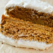 Slice of gluten free pumpkin bread with cream cheese frosting.
