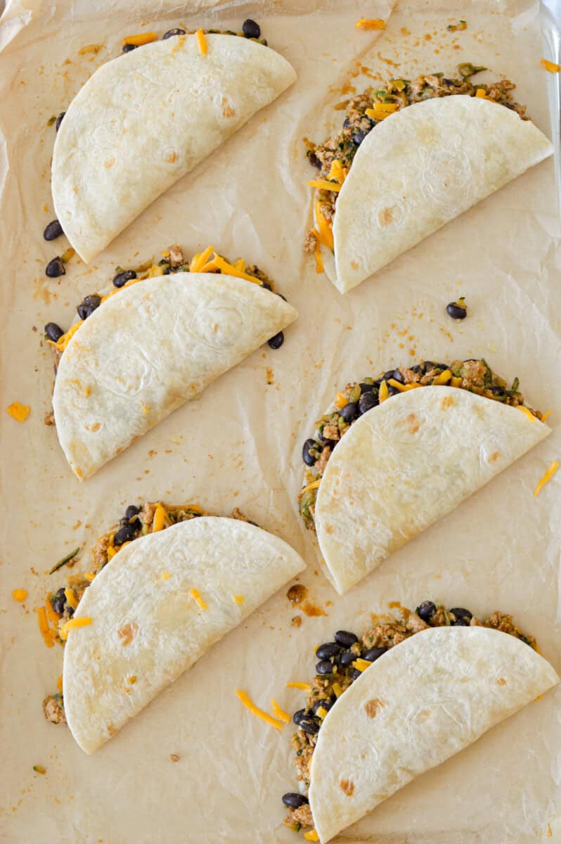 Folding tacos shut.