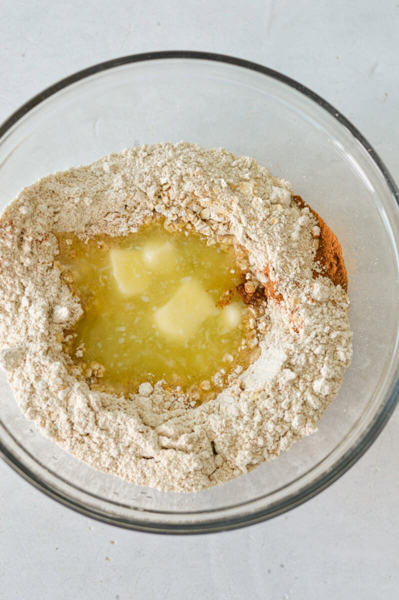 Making oat crumble with oat, oat flour, spices and melted butter.