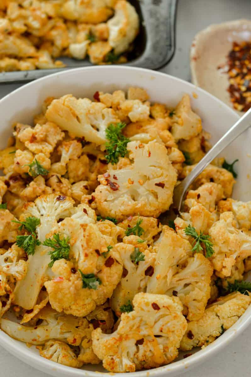 Close up of spicy roasted cauliflower with tahini sauce.