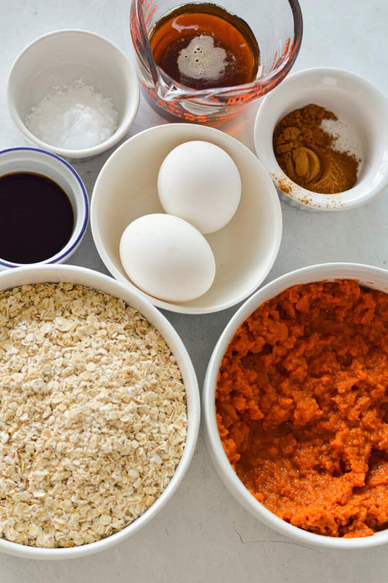 Ingredients including eggs, oats, pumpkin puree, maple syrup, spices and cream cheese.