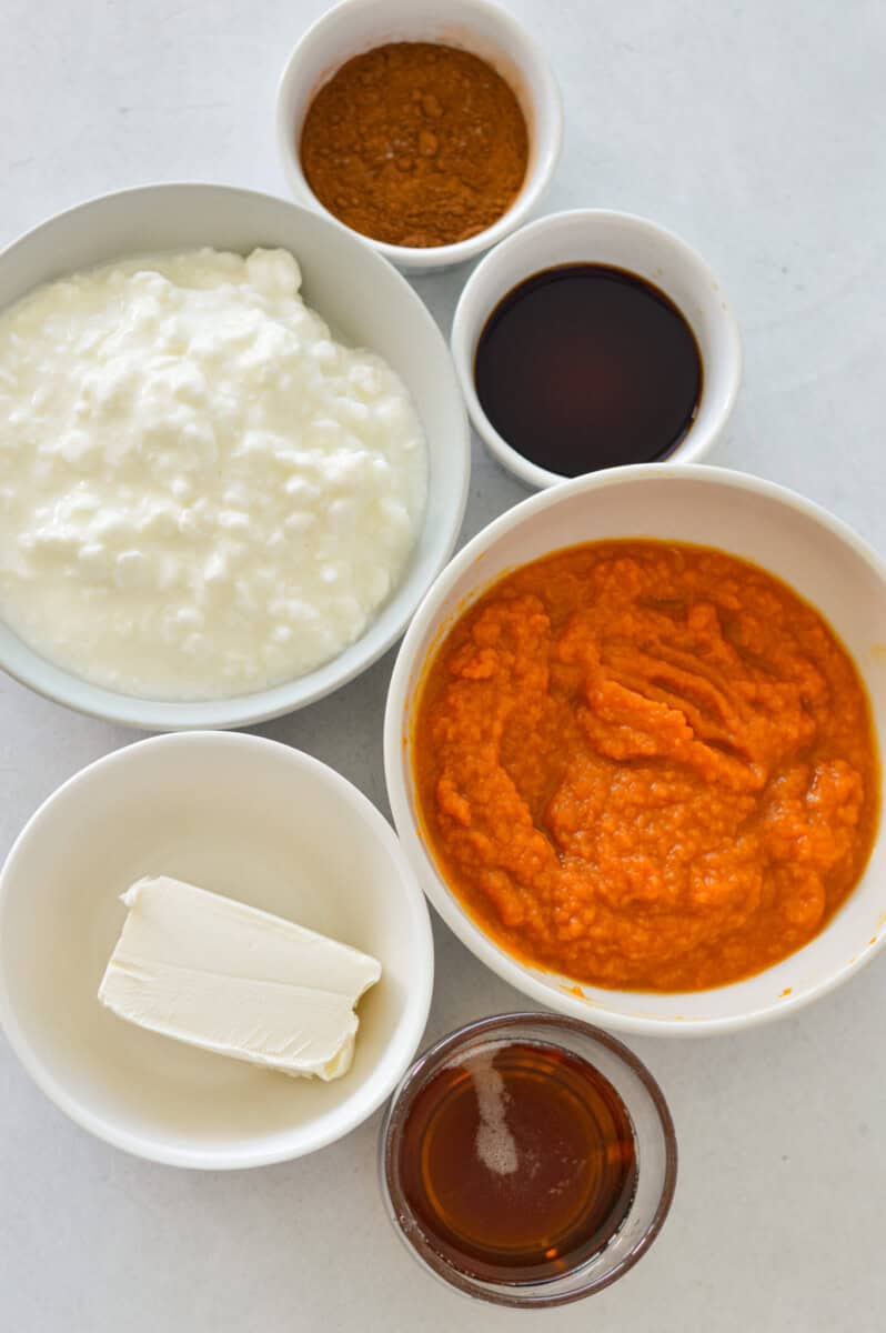 Ingredients including pumpkin puree, cottage cheese, maple syrup, cream cheese, vanilla and spices.