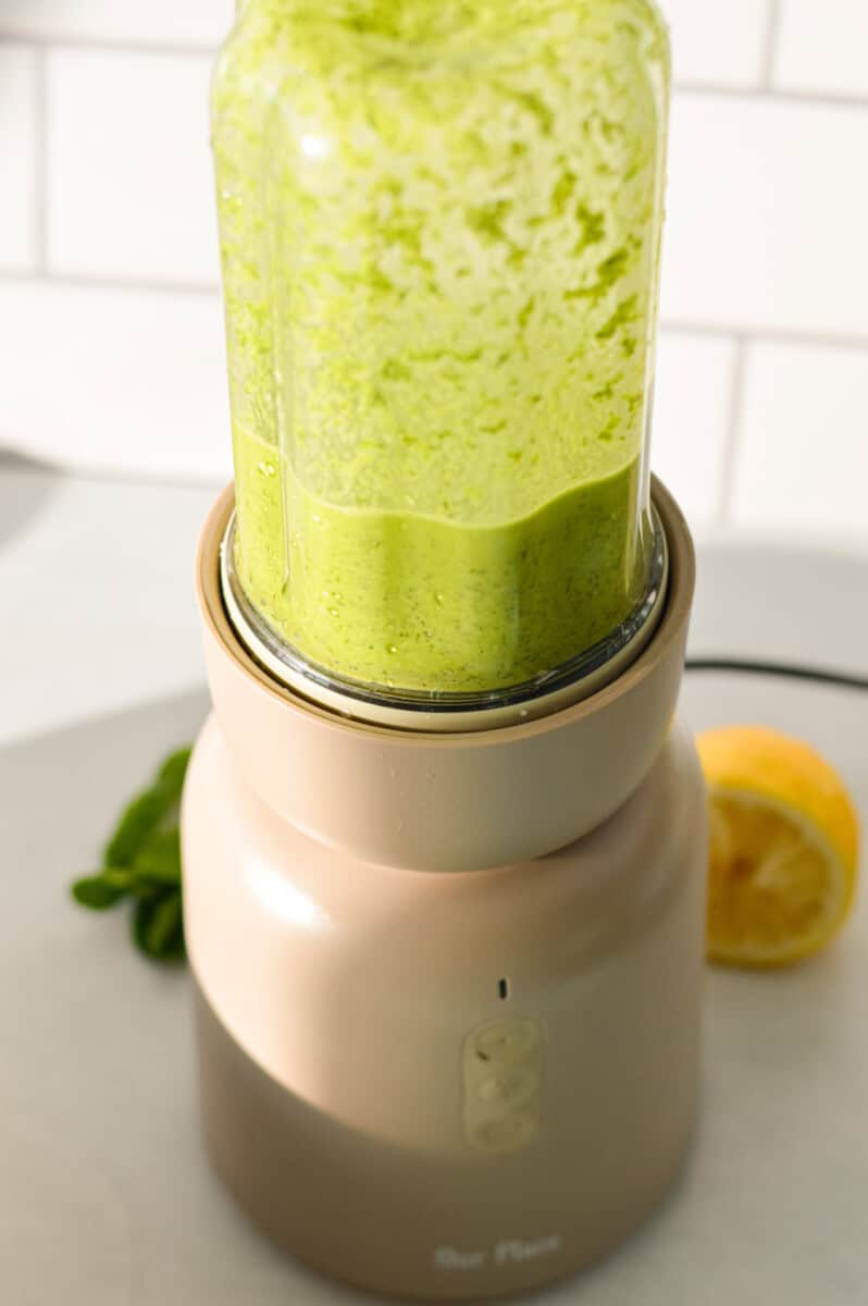 Blending together a fresh herby green goddess dressing.