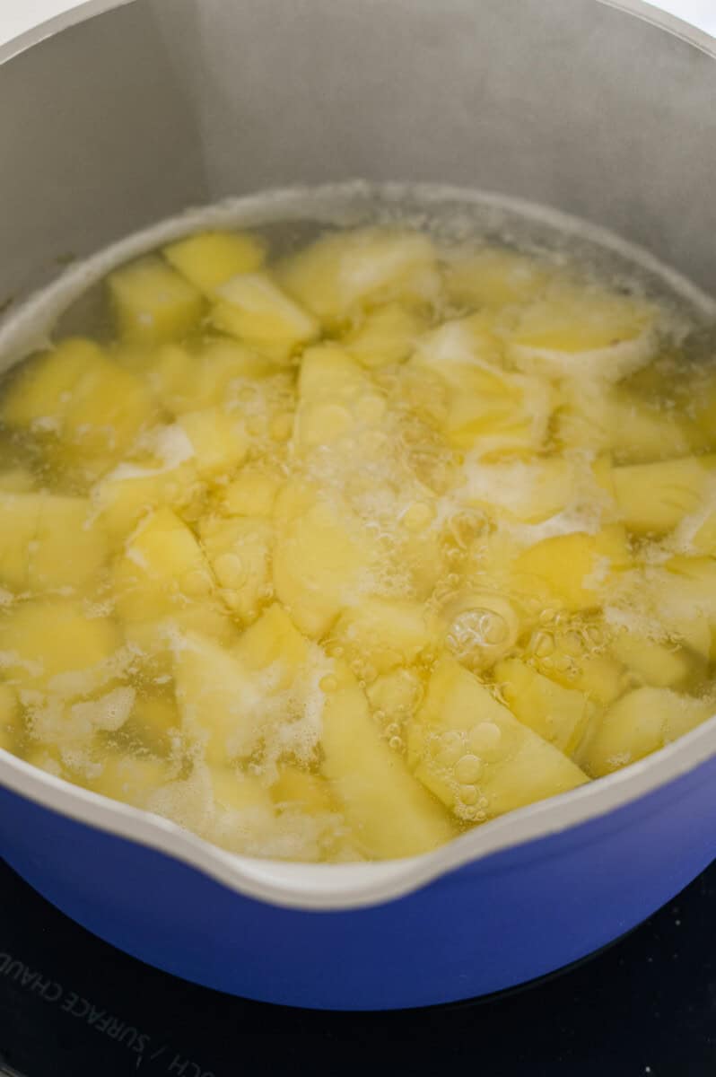 Boiling diced potatoes.