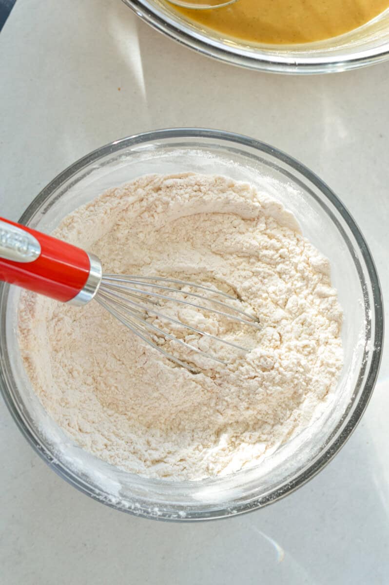Whisking together  flour, baking powder, salt, and cinnamon.
