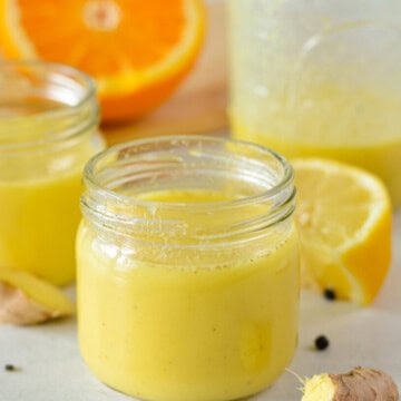 Glass jar with ginger turmeric shot to support immunity.