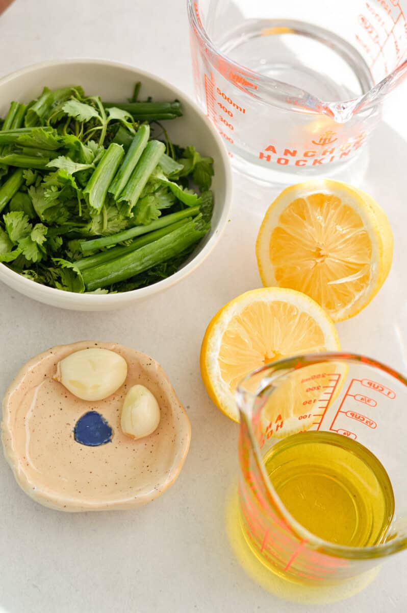 Ingredients including mixed fresh herbs, lemon, olive oil and garlic.