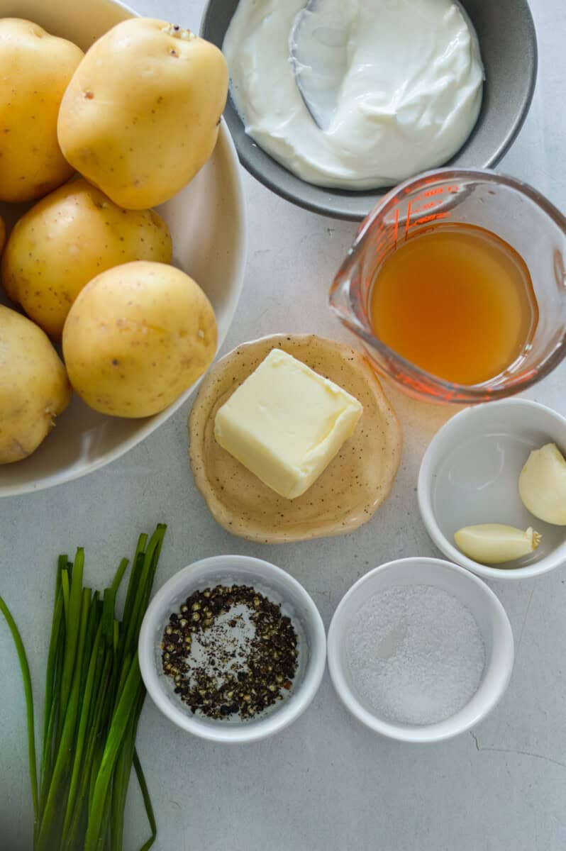 Ingredients including potatoes, broth, btuter, chives, garlic, Greek yogurt and seasoning.