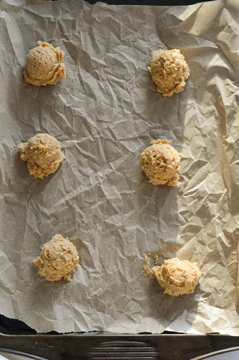 Rolling out cookie dough balls.