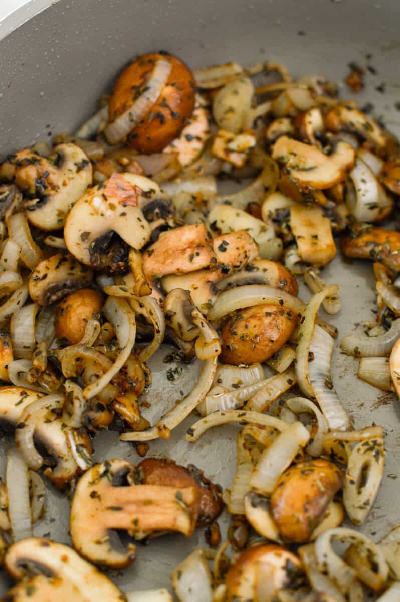 Sauteeing shallots and mushrooms in a pan.
