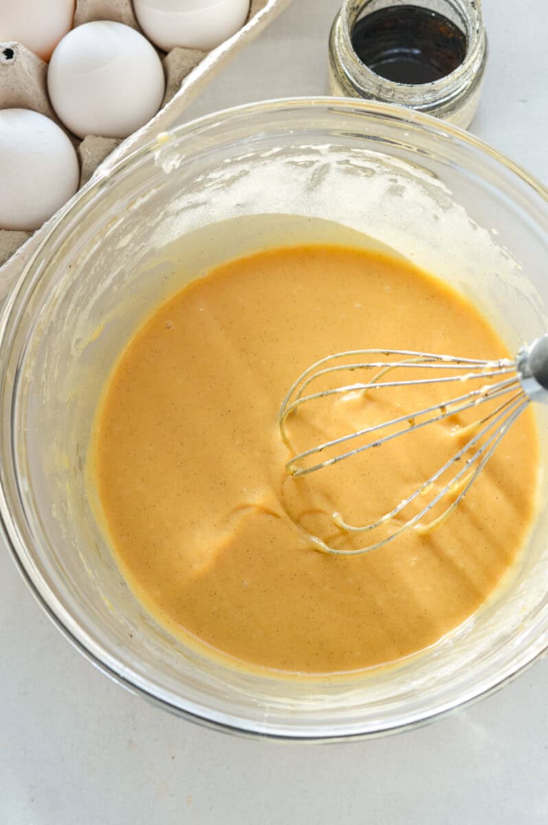 Whisking eggs into sugar and butter mixture.