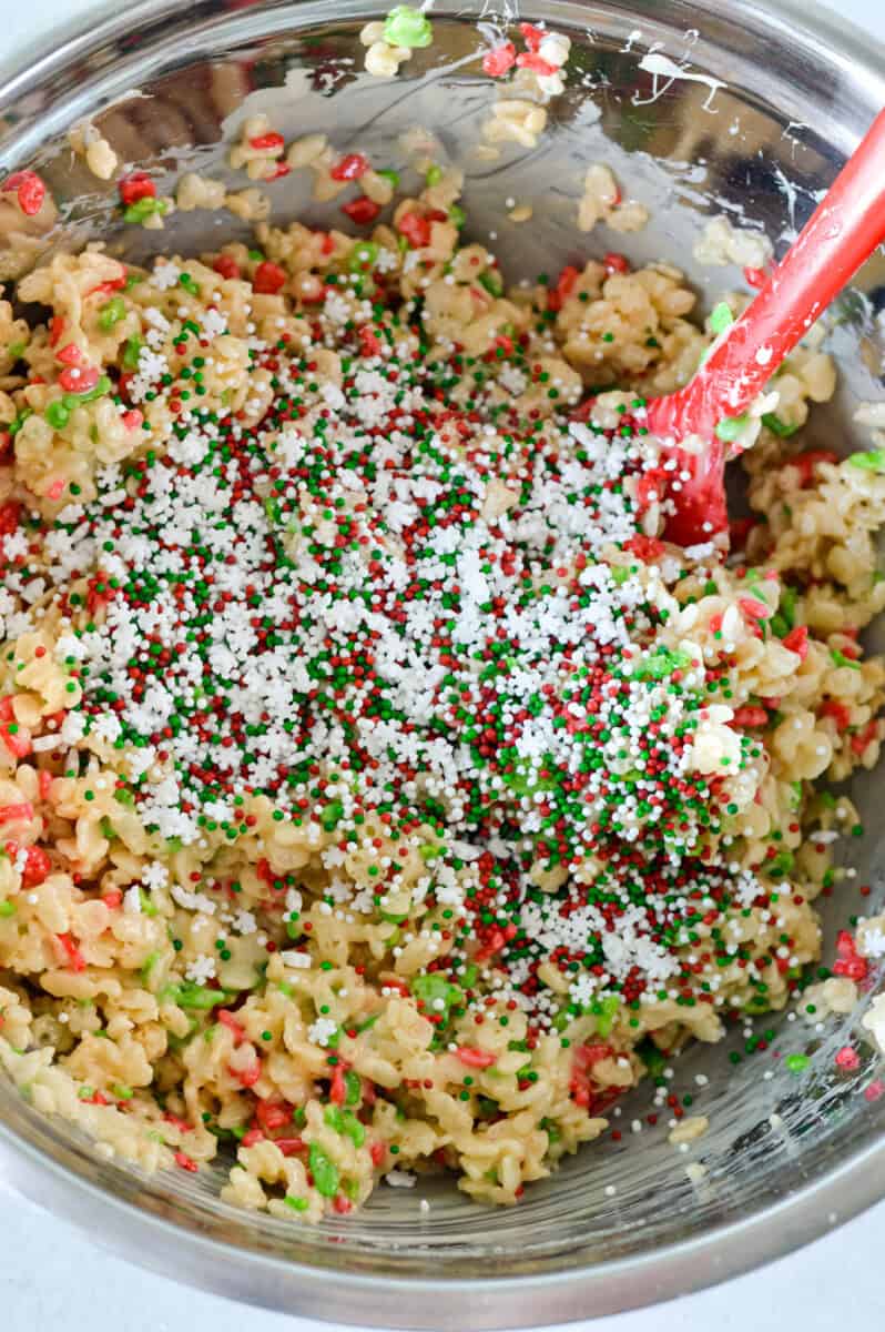 Mixing rice krispies and sprinkles into marshmallow and butter mixture.
