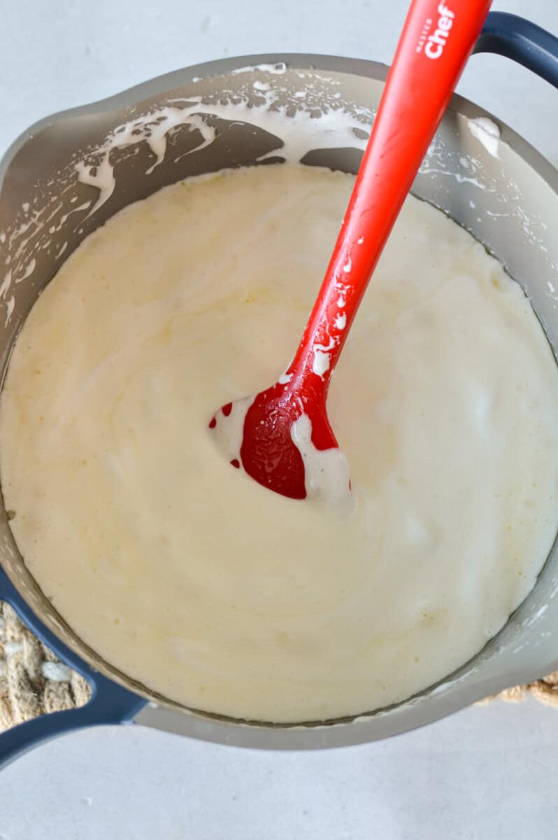 Mixing marshmallows into melted butter mixture.