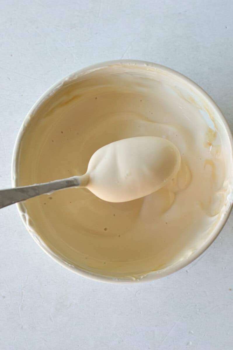 Mixing together a sweetened yogurt topping.